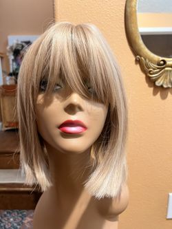 12” Blonde Wig with a highlights. Enhance your look with this chic blonde wig. Perfect for any occasion, it offers a natural and stylish appearance. S