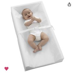 Changing pad with a white wood holder to set on top of a dresser. 