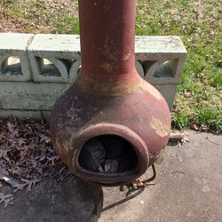 
Heavy full sized clay chiminea set on iron base