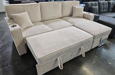 Beige corduroy sectional sofa with pullout sleeper sofa bed with cup holders