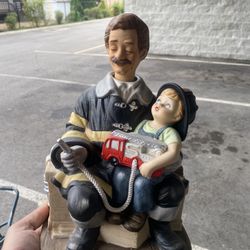 Waco Melody In Motion "When I Grow Up" musical figurine featuring a firefighter and a young boy.  This hand-painted porcelain figurine plays the tune 
