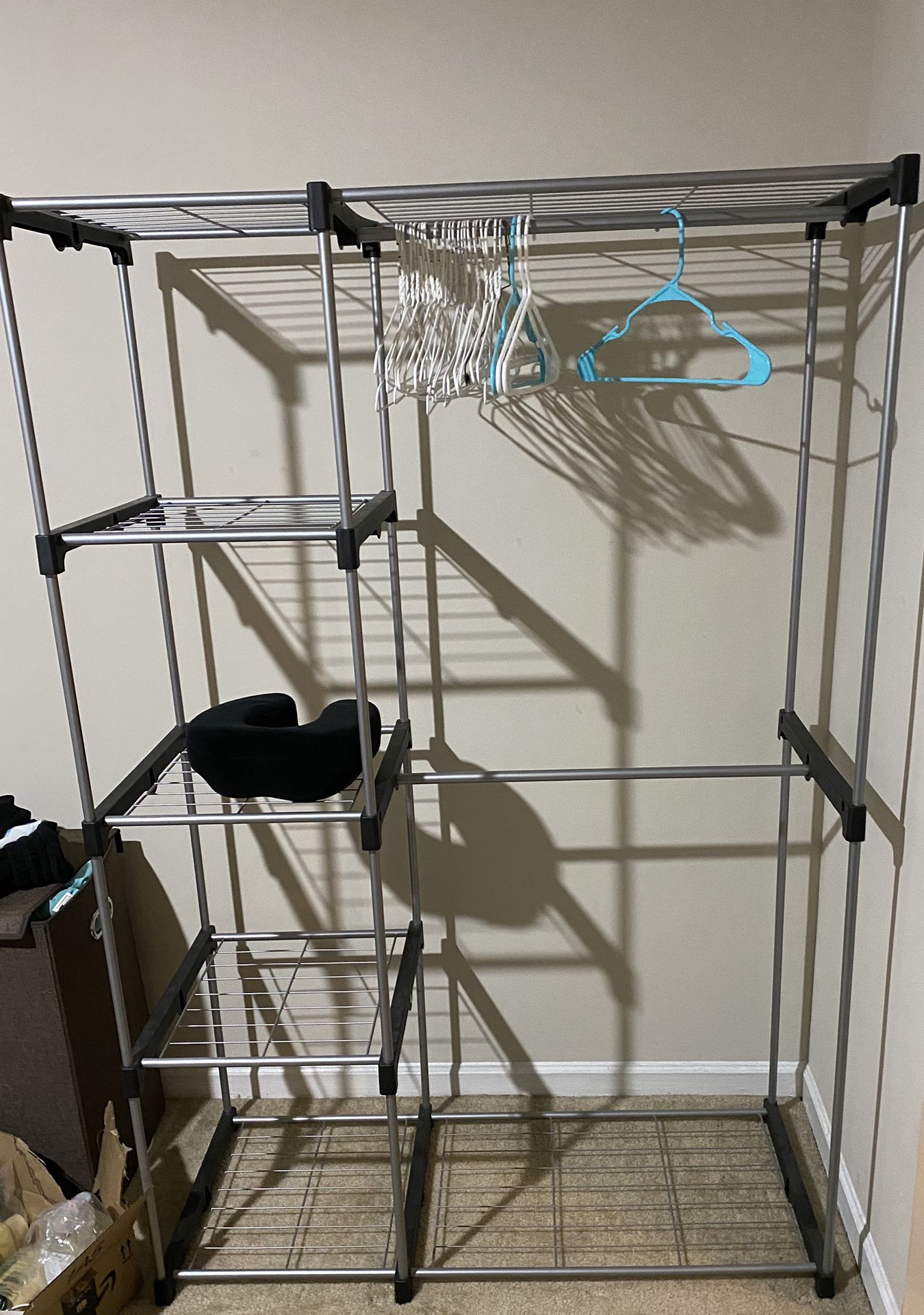 Portable clothing rack with different compartments