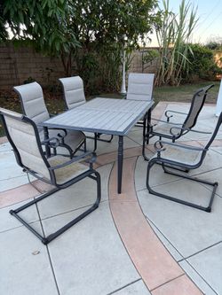Outdoor patio table with chairs and benches