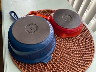 LeCreuset Enamel coated cast iron skillet in orange with LeCreuset enamel coated cast iron sauce pan