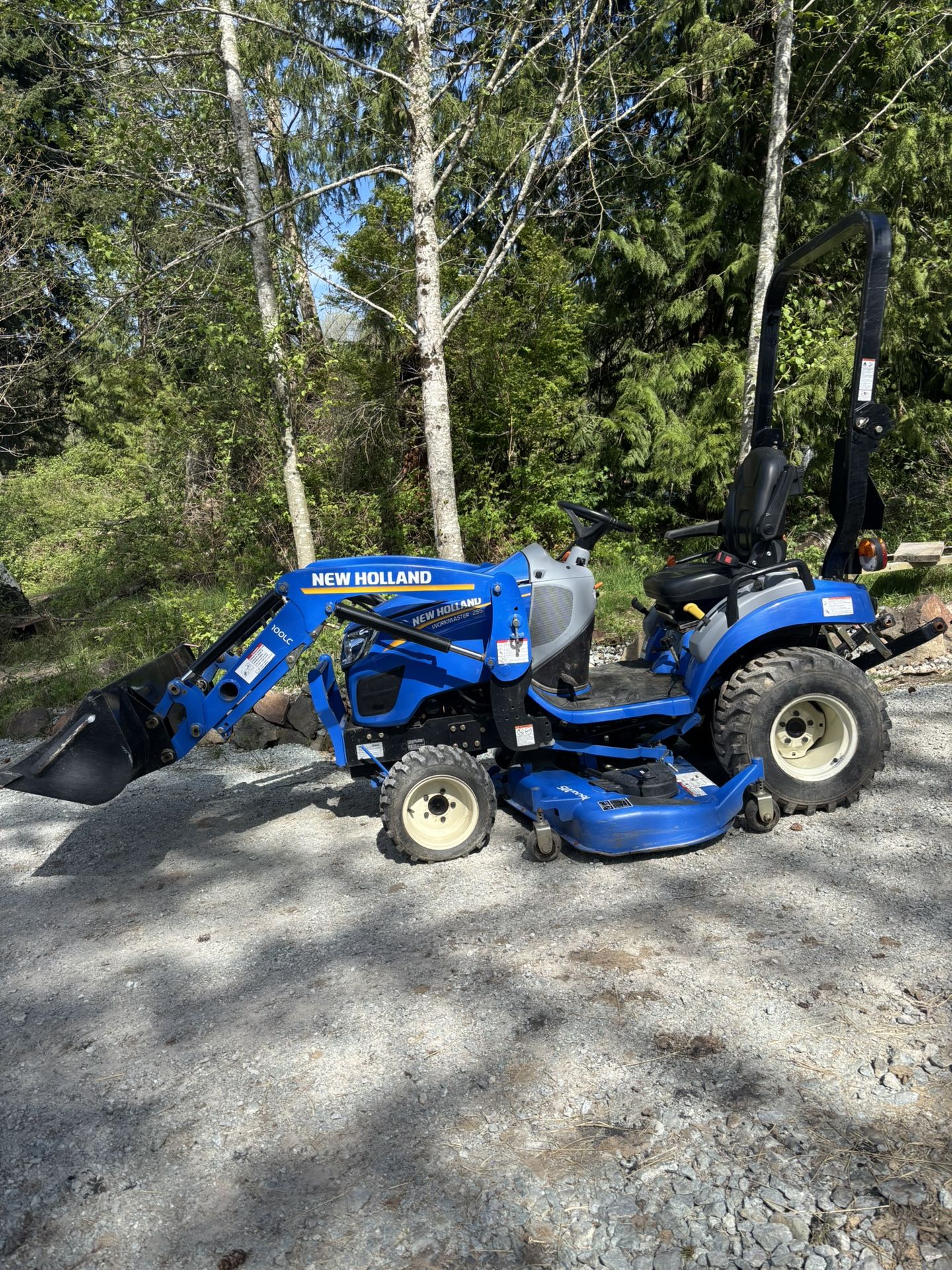 Tractor With Loader, Mower, And Rototiller