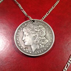 1921. MORGAN WITH A HOLE DRILLED TO CREATE A NECKLACE 🤔. W SILVER FIGARO "28