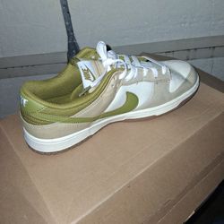 Used But Great ShNike Dunk Low in the "Pacific Moss" colorway, featuring a white leather base with neutral olive overlays and a color-matched Swoosh. 