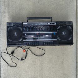 vintage General Electric (GE) 2+2 dual cassette boombox, likely model 3-5676A. 
It features dual cassette decks with high-