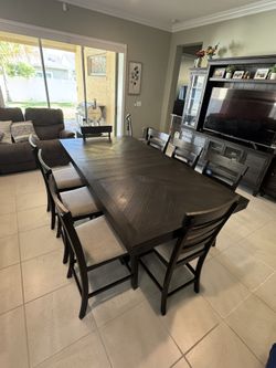 Dark brown counter height Dining Table With 8 Chairs.