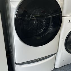 Front load Whirlpool washer on pedestal