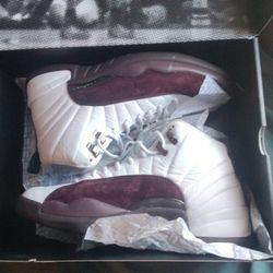 Jordan 12 Retro SP x A Ma Maniére in the white and burgundy crush colorway. 