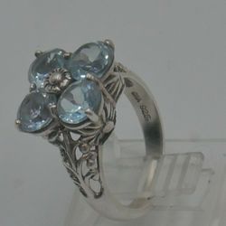 STERLING SILVER 925 RING 4.5 GRAMS SIZE 6 WITH 4 LIGHT BLUE STONES MINT CONDITION.  866077-2.  