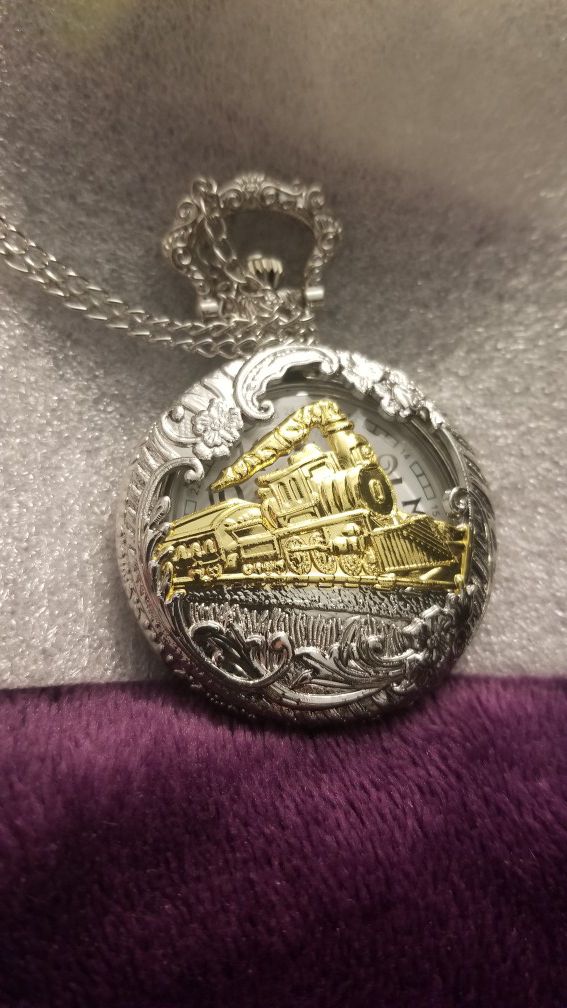 Pocket chain watch with train on it.