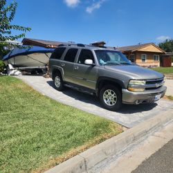 2002 Chevy, Tahoe, 4 wheel drive and boat and trailer.