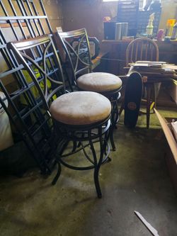 Two bar stool chairs with cushions