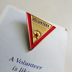 1" Golden Triangular Volunteer Dress Shirt Lapel Pin with Red Enamel Inlay. A Volunteer is like a shinning star. Thank You for your time.  New old sto