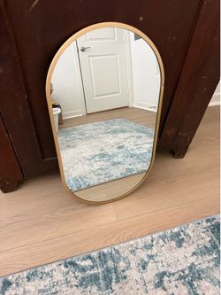 Gold oval mirror