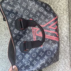 Red and black Louis Vuitton, duffel bag monogram