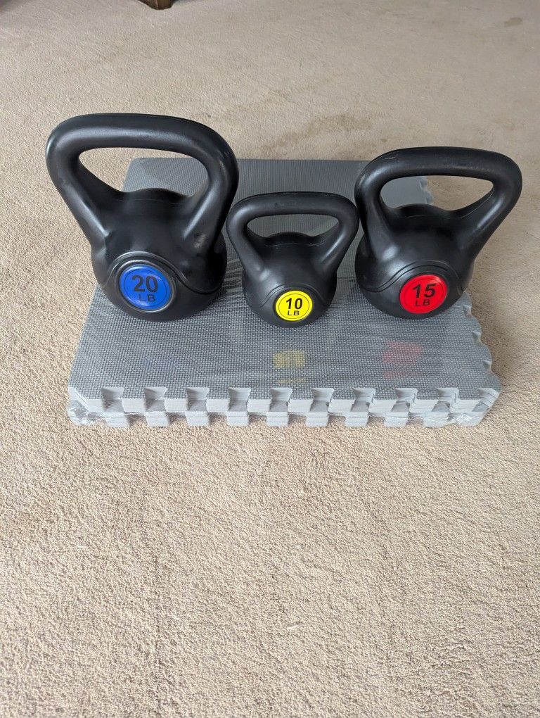 Brand New Set Of Kettlebells As Well As A Pack Of Mats