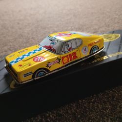 Vintage tin Pro Stock car with multi avertisments  STP,champion plugs