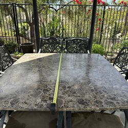 Beautiful 64” x 64” stone table and 8 heavy duty powder coated durable aluminum armchairs