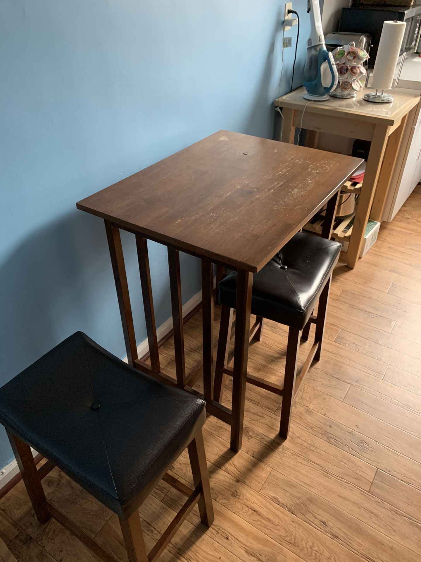 Solid wood kitchen table with stools. Has had use with scratches and nicks and stains. Overall very solid