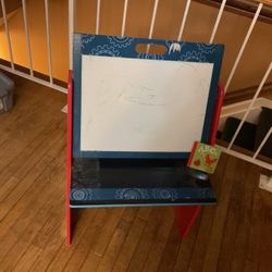 A Good Children Board To Write With Storages On The Other Side.  Two Headphones ,one With A Speaker, A Winter Hat And A Doty Dog