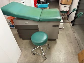 Adjustable medical exam table with power outlet