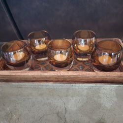Wooden and glass centerpiece candle holder with a design featuring 5 amber candle holders.