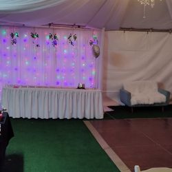 Rectangular tables 8' tablecloths white wooden chairs artificial grass tents