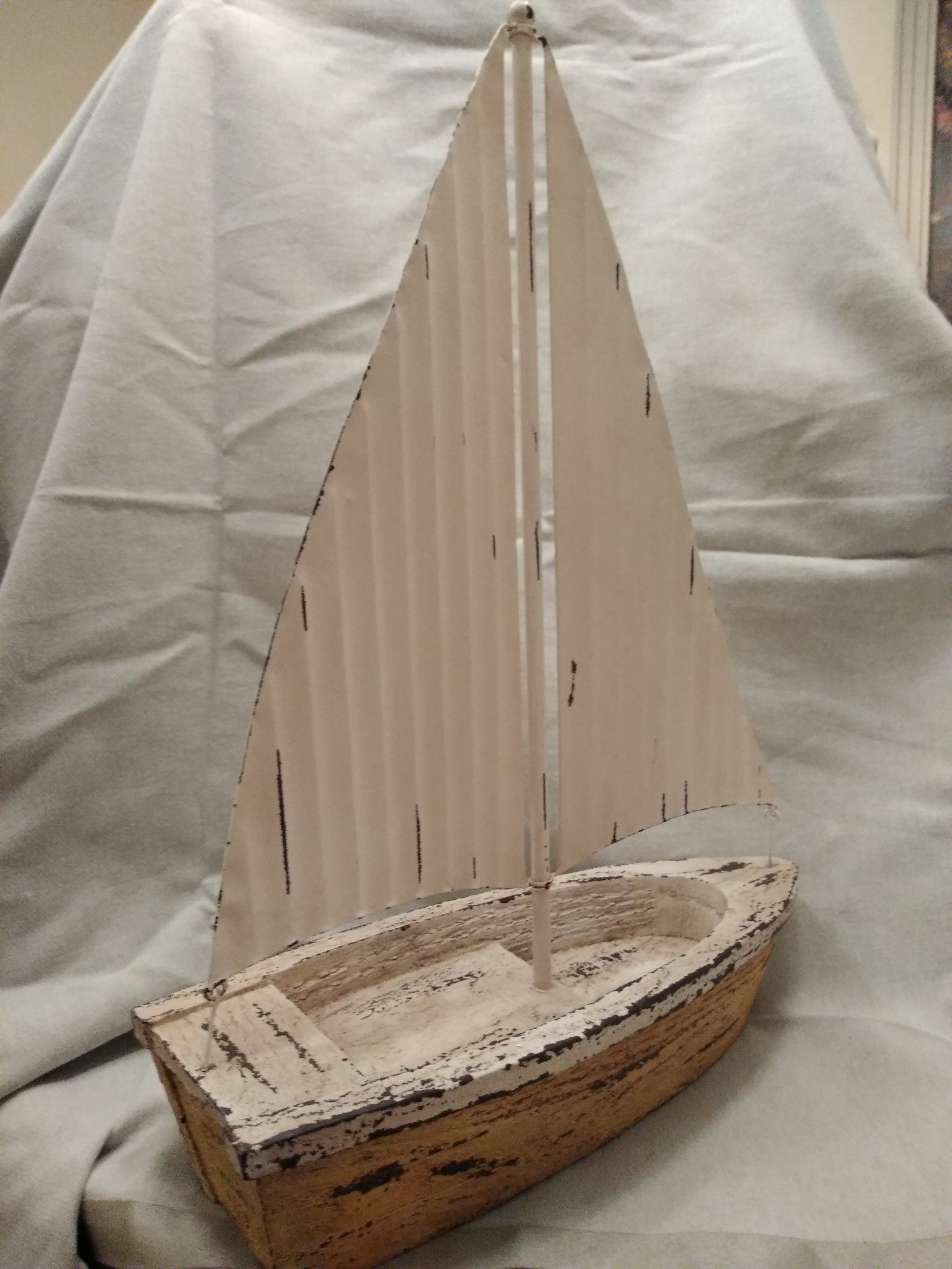 Sailboat featuring a metal rustic-looking sail