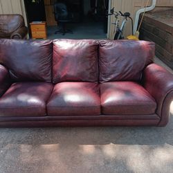 BURGUNDY LEATHER SOFA.
