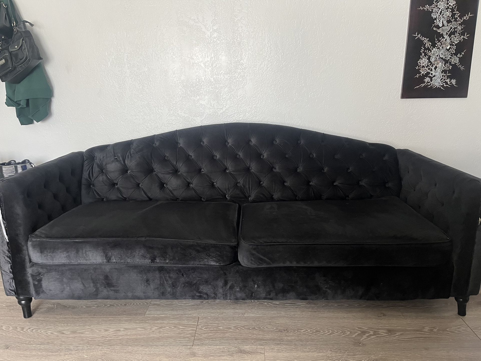 tufted black suede couch