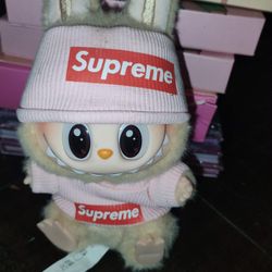 Labubu plush toy wearing a custom pink Supreme outfit 
