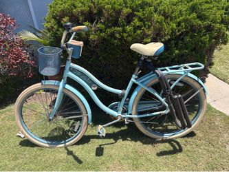 Huffy Nel Lusso Women's Cruiser Bike in light blue with a front basket and rear cargo rack