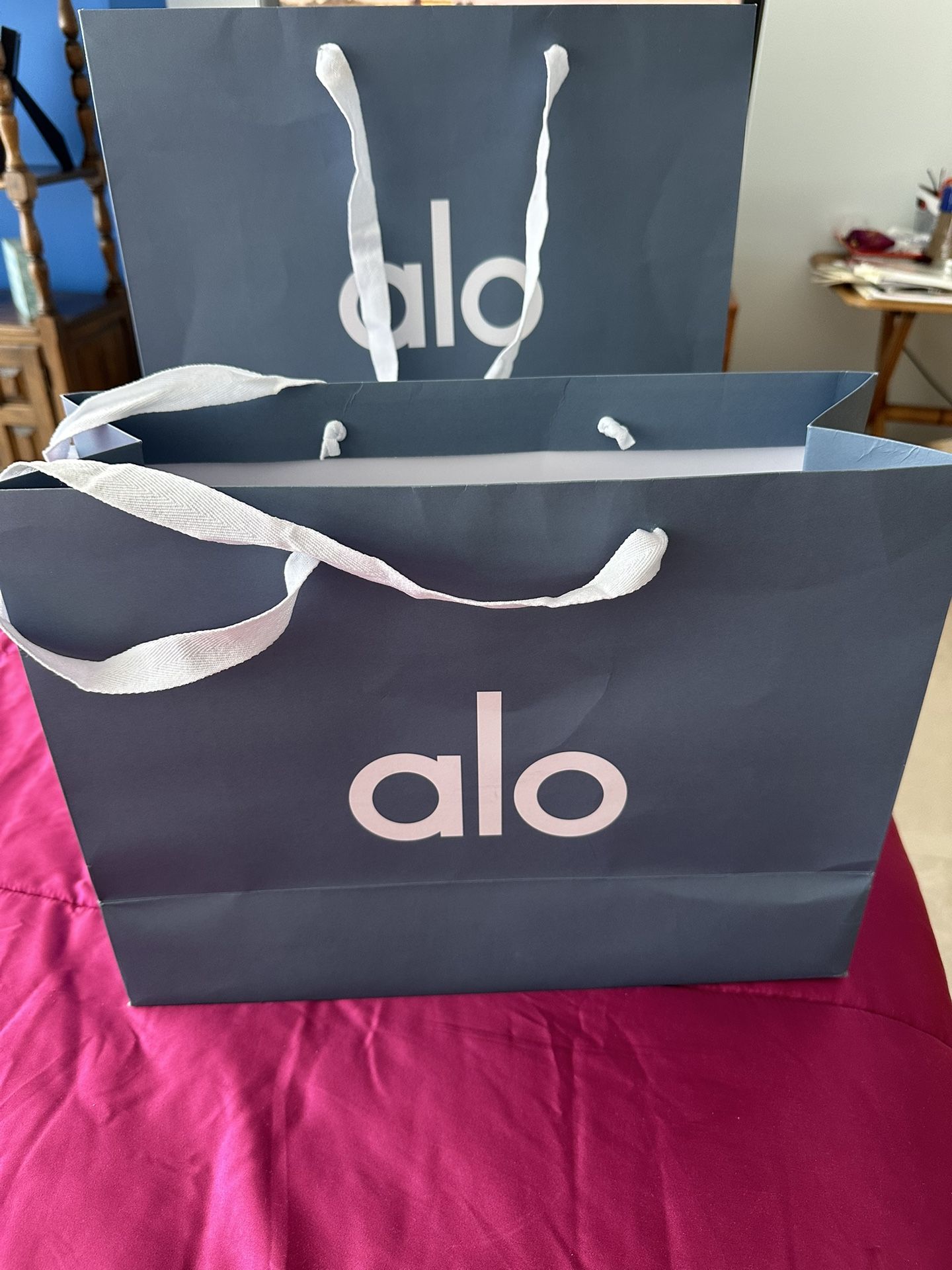 2 Alo sportswear bags w one merchandise tag for yoga attire. beautiful condition in their grayish blue color and white cloth carrying handles