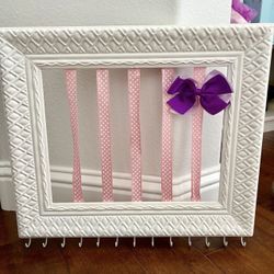 Adorable Girls Hair Bow And Jewelry Accessory Holder   Has hooks on the bottom for necklaces or jewelry or hair ties.  Hangs on the wall.  In good con