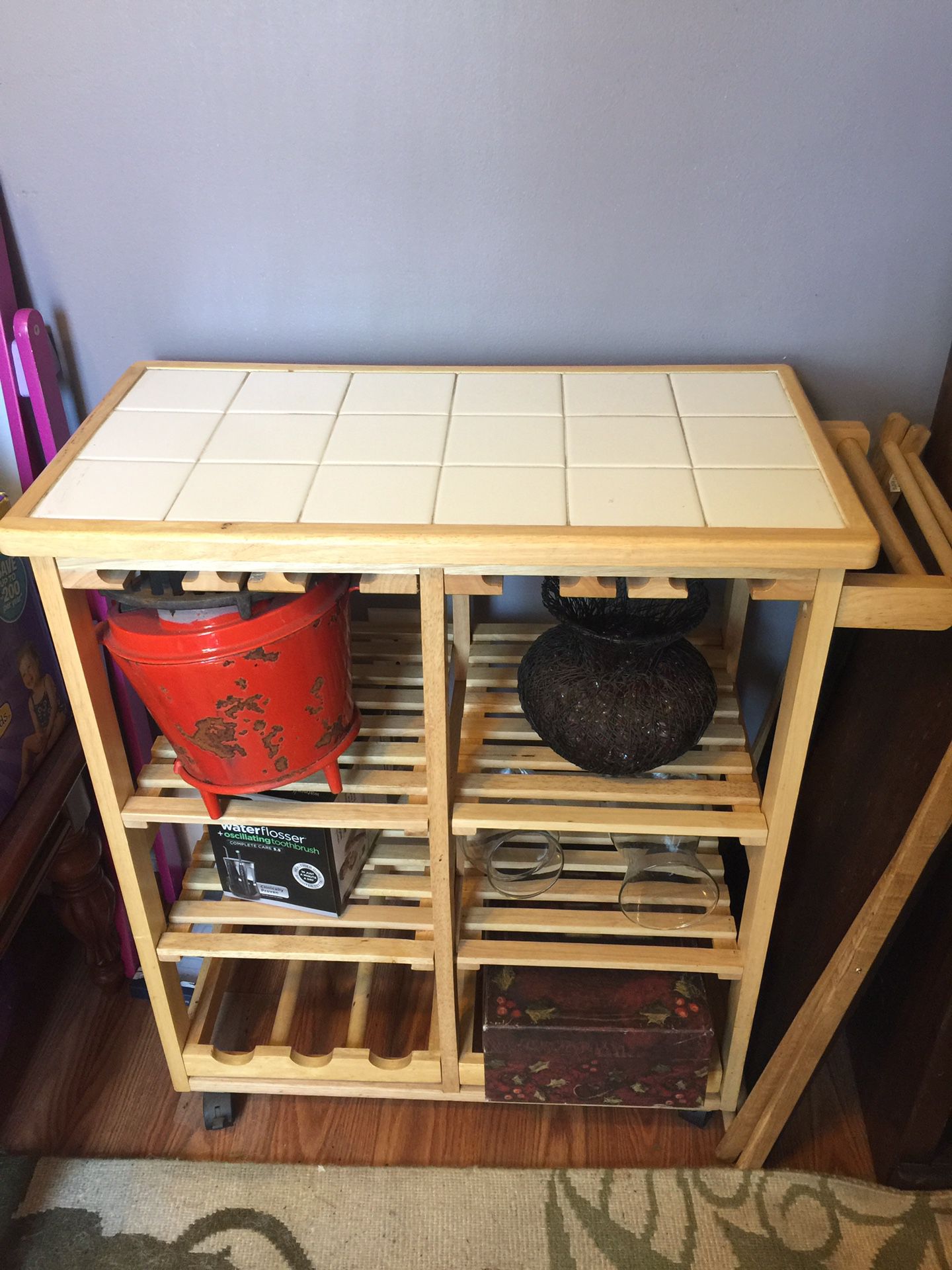 Kitchen cart with wine bottle and glass holders as well as shelves