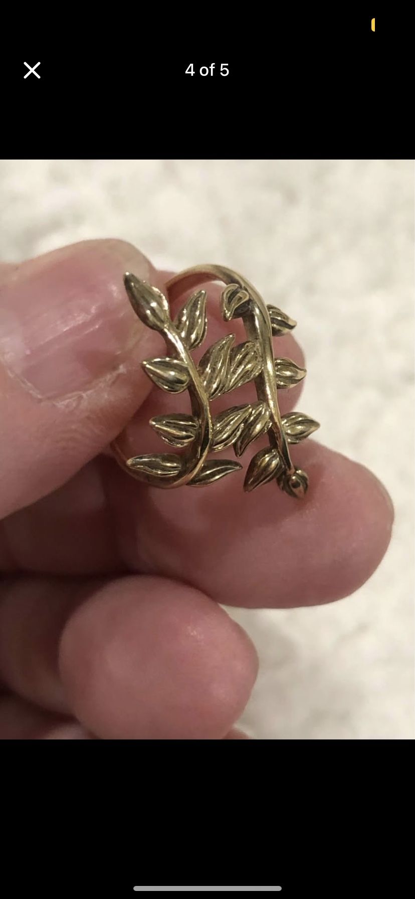 Gold plated over .925 silver ring. Beautiful leaves around your finger, and is adjustable.