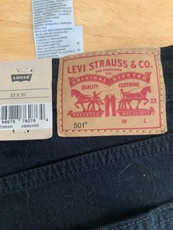 Women’s Levi’s 501 jeans - black denim boot cut.  Never worn with tags