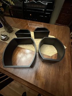 set of black wooden nesting wall shelves, likely for home decor or display purposes