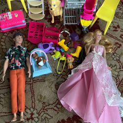 A Barbie doll and a Ken, shoes, and accessories.