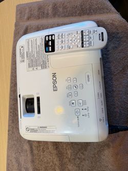 The Epson H719A (EX3240) LCD Projector is a white desktop unit with a lens magnification of less than 3x and an aspect ratio of 4:3. It offers a maxim