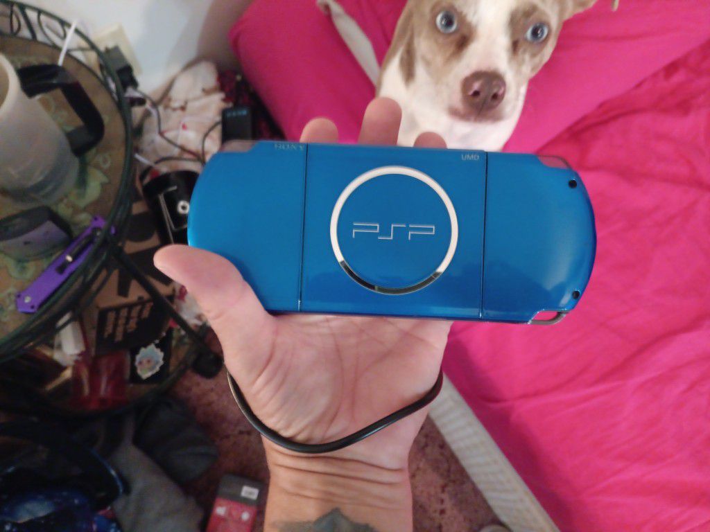 BLUE PSP WITH GAMES CHARGERS AND CASE