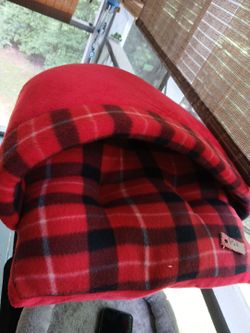 A dog bed cat or dog bed shoe shaped