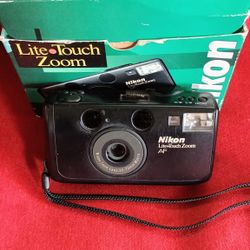 Nikon Zoom 300 AF Nikon Lite Touch point-and-shoot 35mm film camera in its original box. 
 35-70 mm film camera with built-in flash and brand new bat