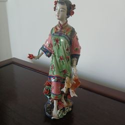 Chinese Famille Rose porcelain figure of a lady holding a string of fish