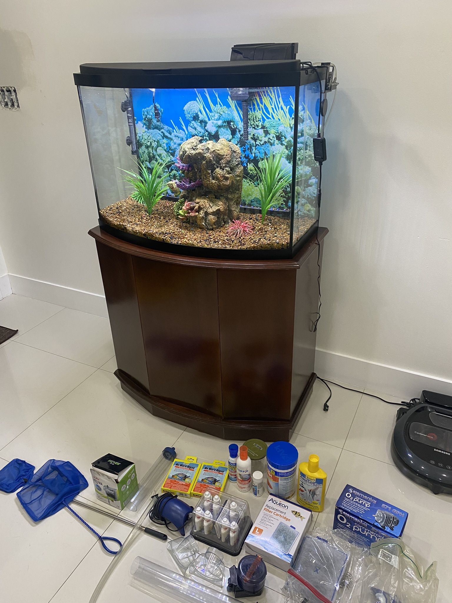 Fish tank with custom-made wooden cabinet with drawer and all the necessary accessories for care