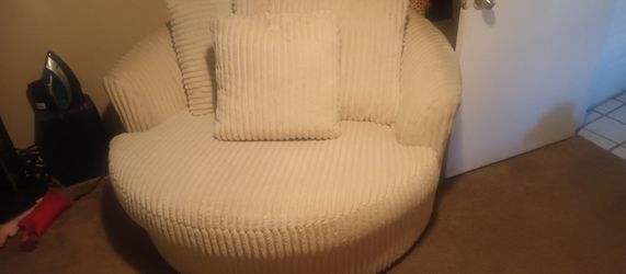 Cream colored sofa and swivel chair