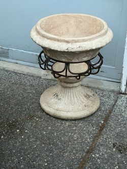Bombay brand planter features a white distressed cement bowl set into a black metal stand.